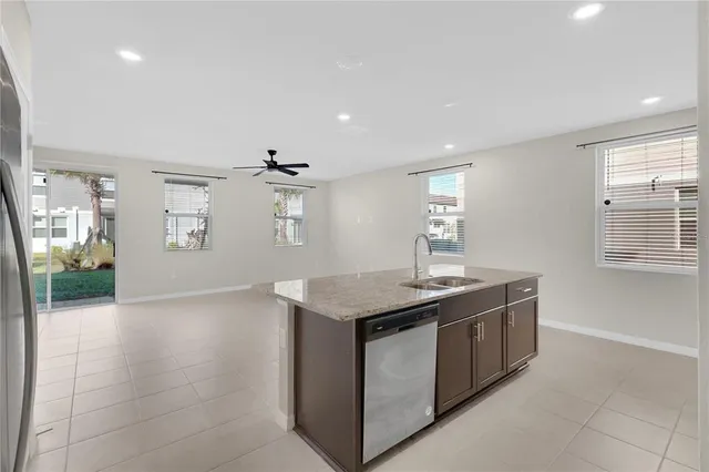 a kitchen with stainless steel appliances granite countertop a sink and a stove