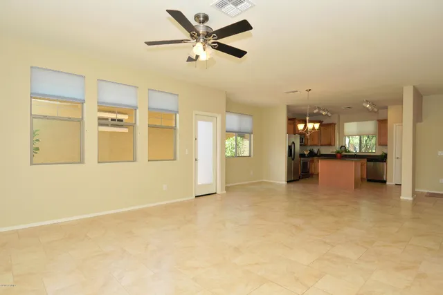 a view of an empty room with a kitchen