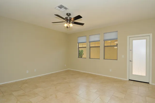 a view of a hallway to a room with wooden floor and staircase