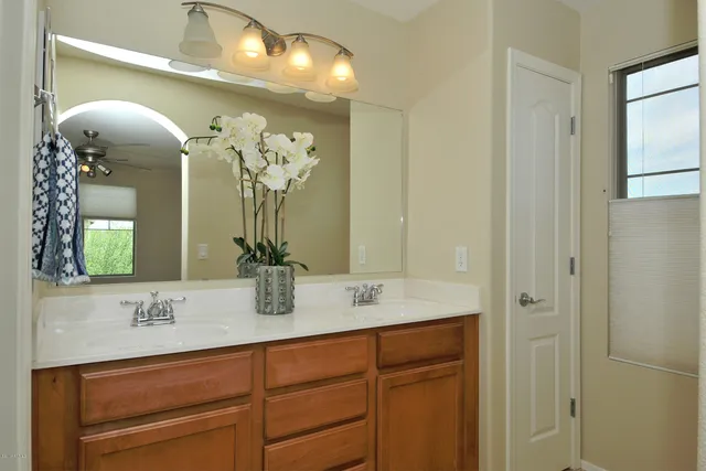 a bathroom with a double vanity sink and a mirror