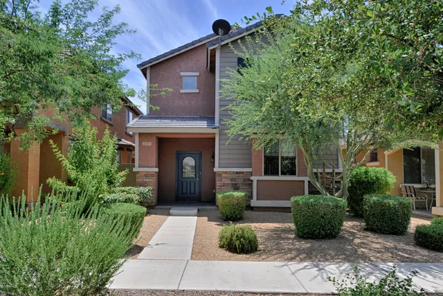 a front view of a house with a garden