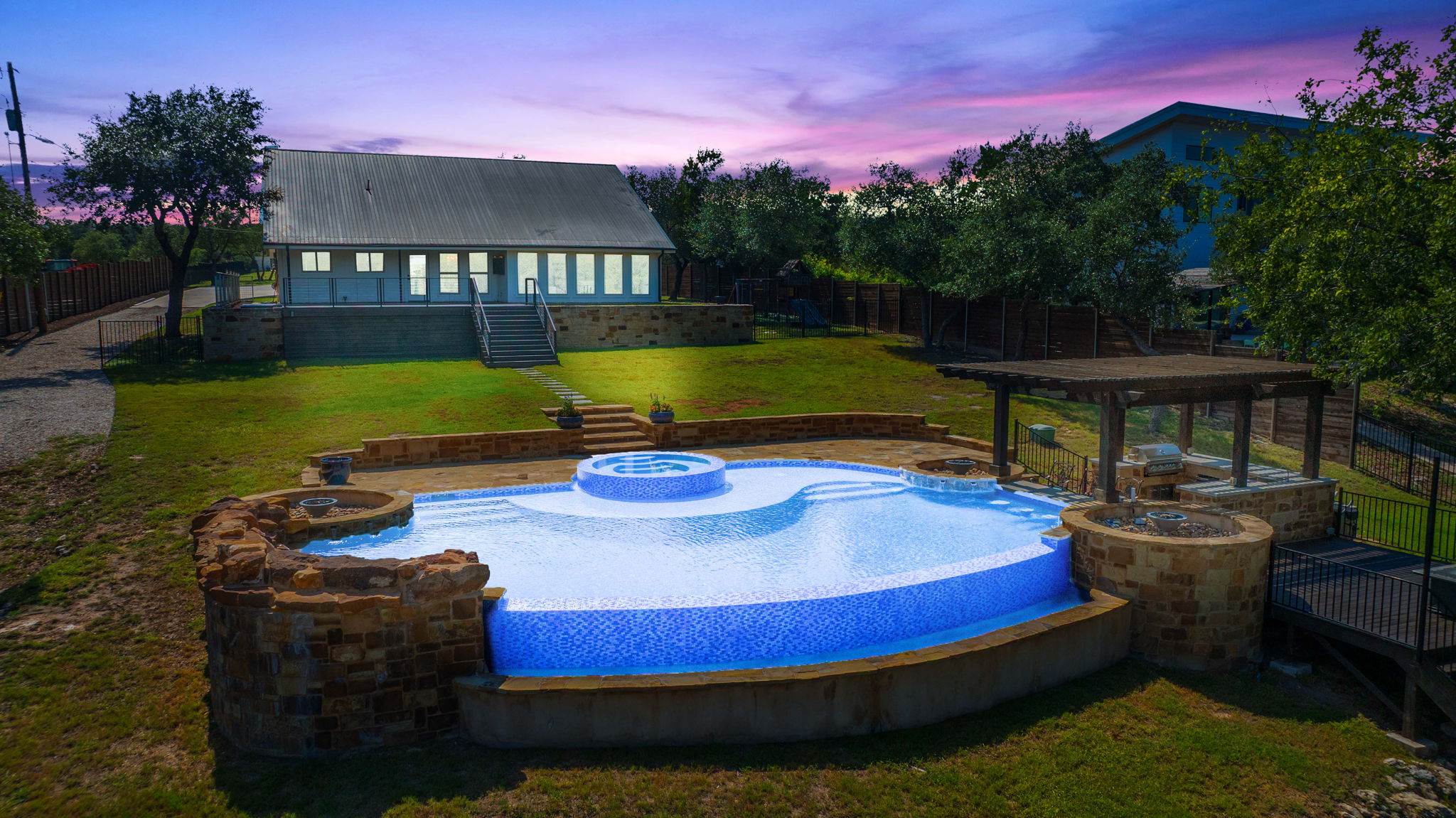 Integrated pool / spa with a patio, a fenced backyard, and a wooden deck