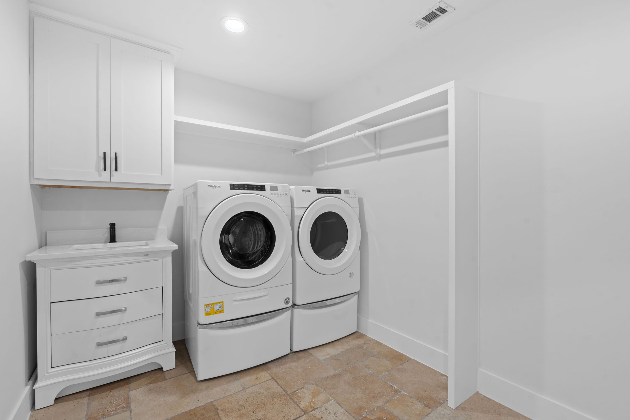 1325 Likeness Road Spicewood, TX 78669 - Photo 21 of 40 Laundry room featuring cabinet space, stone tile floors, washer and clothes dryer, and recessed lighting