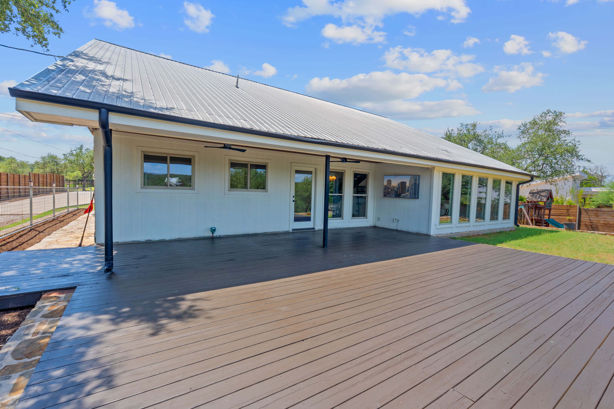 1325 Likeness Road Spicewood, TX 78669 - Photo 23 of 40 Deck with a playground and ceiling fan