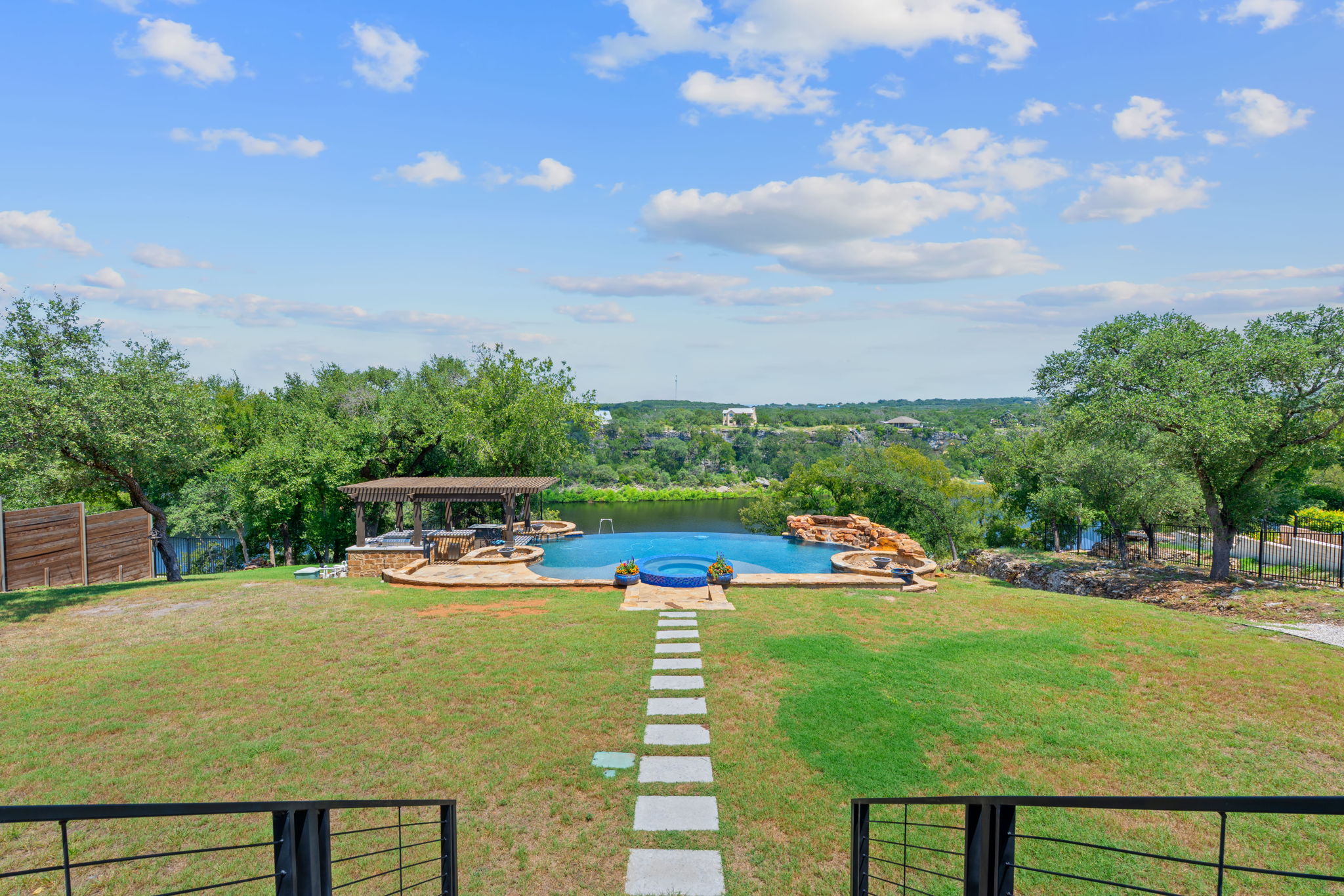 1325 Likeness Road Spicewood, TX 78669 - Photo 24 of 40 Integrated pool / spa with a patio and view of wooded area