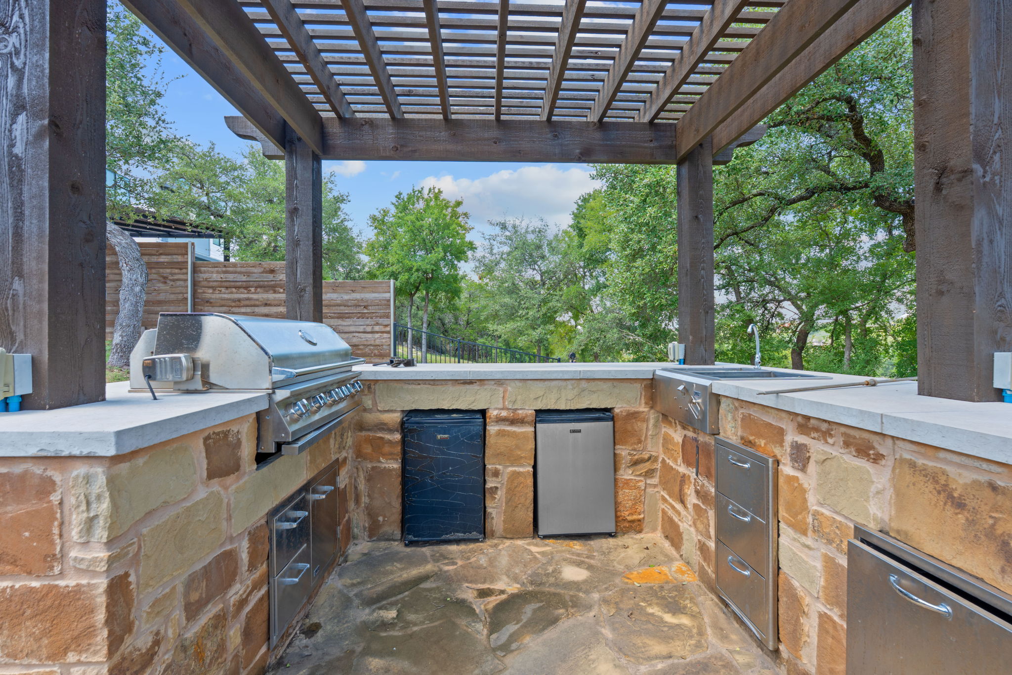 1325 Likeness Road Spicewood, TX 78669 - Photo 29 of 40 View of patio featuring a pergola, exterior kitchen, and wine cooler