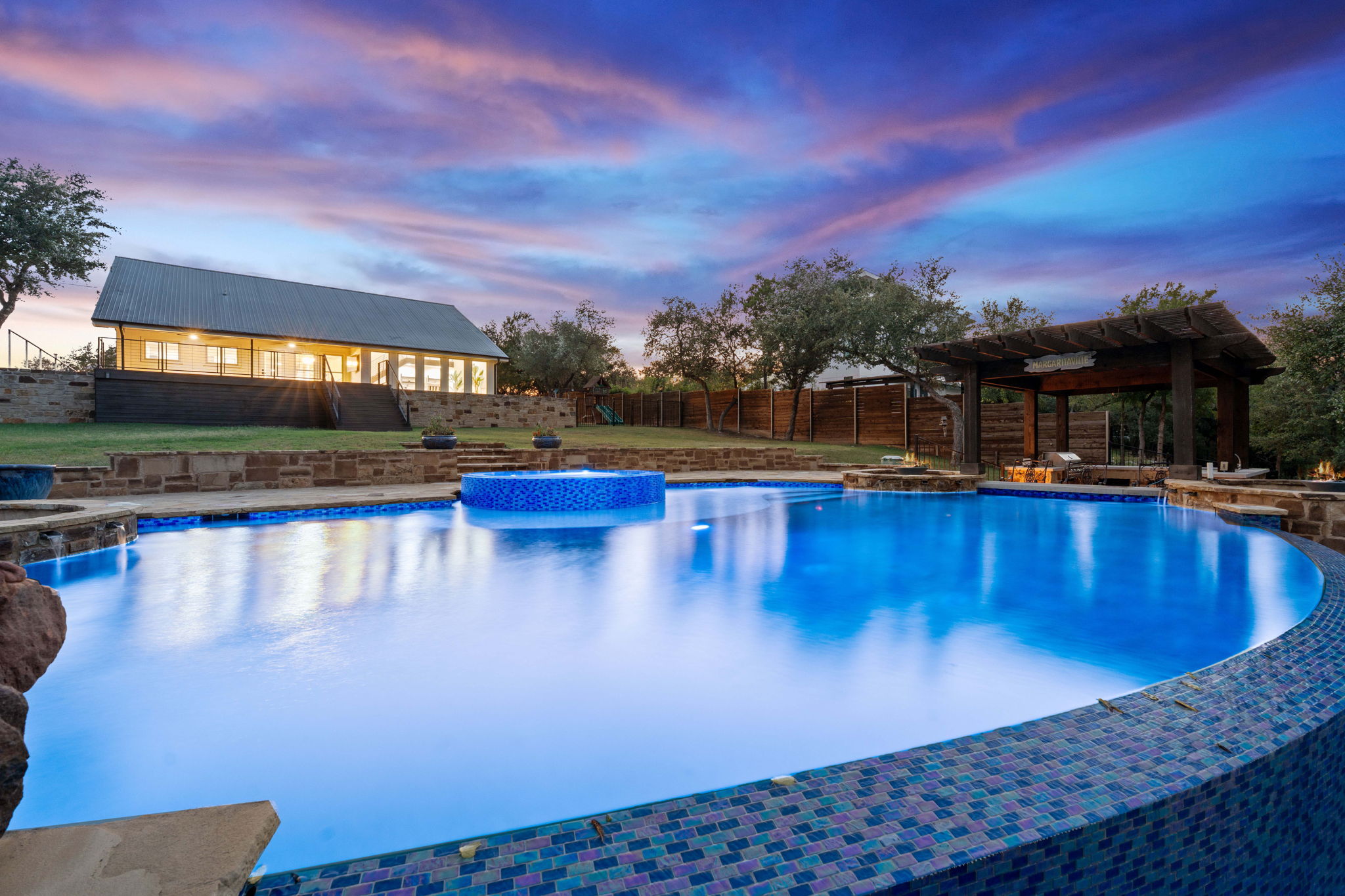 1325 Likeness Road Spicewood, TX 78669 - Photo 3 of 40 Integrated pool / hot tub with a patio and a fenced backyard