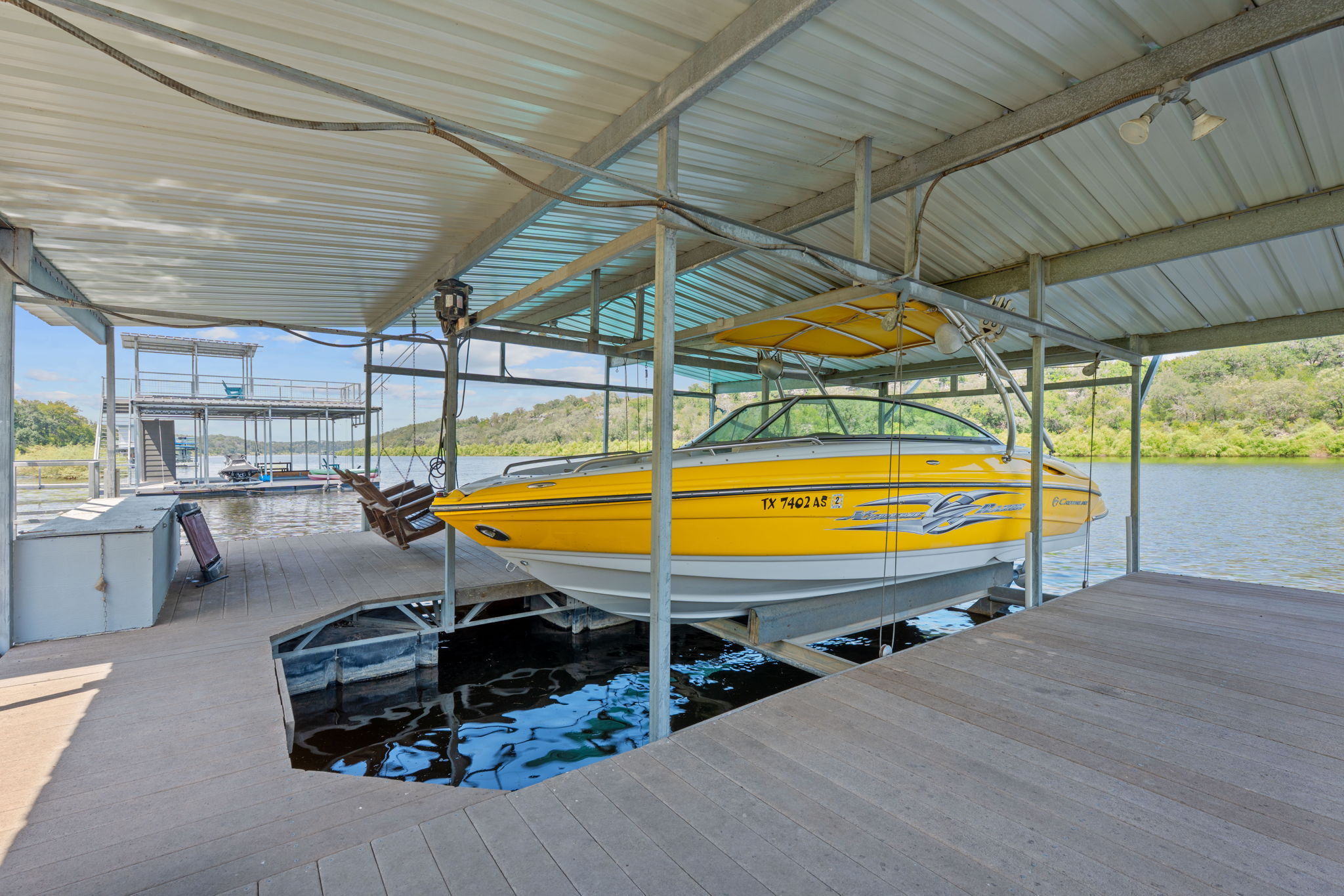 1325 Likeness Road Spicewood, TX 78669 - Photo 32 of 40 Dock area featuring boat lift and a water view