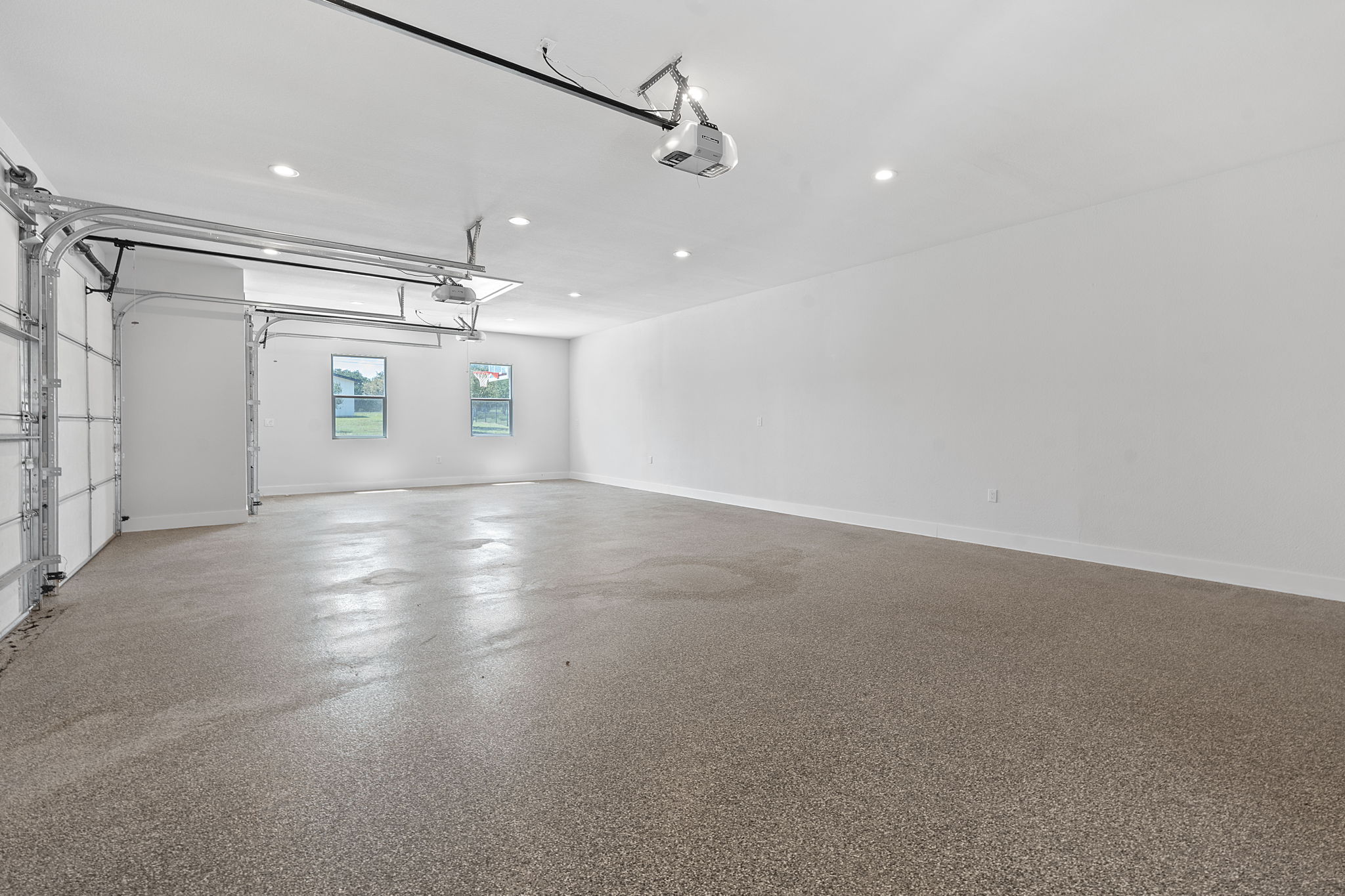 1325 Likeness Road Spicewood, TX 78669 - Photo 33 of 40 Garage with recessed lighting and a garage door opener