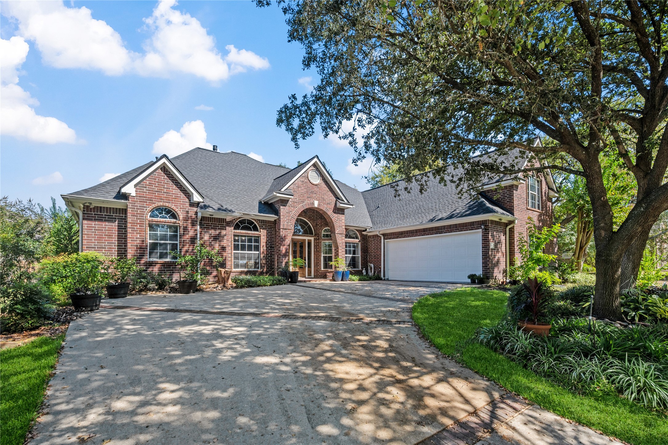 319 Palais Verde Road Montgomery, TX 77356 - Photo 1 of 40 This charming brick home features a spacious two-car garage and a welcoming arched entryway. The well-maintained landscaping includes mature trees and manicured gardens, offering excellent curb appeal in a serene neighborhood setting.