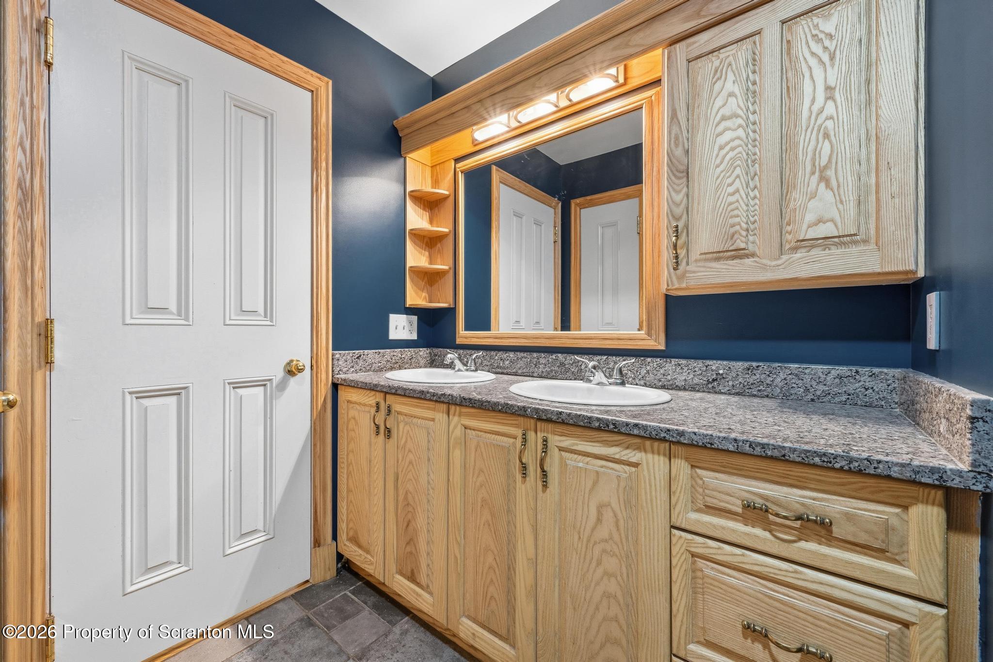 116 Forge Street Old Forge, PA 18518 - Photo 19 of 49 a bathroom with a granite countertop sink and a mirror