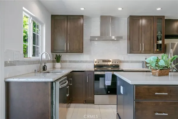 a kitchen with a sink stove and cabinets