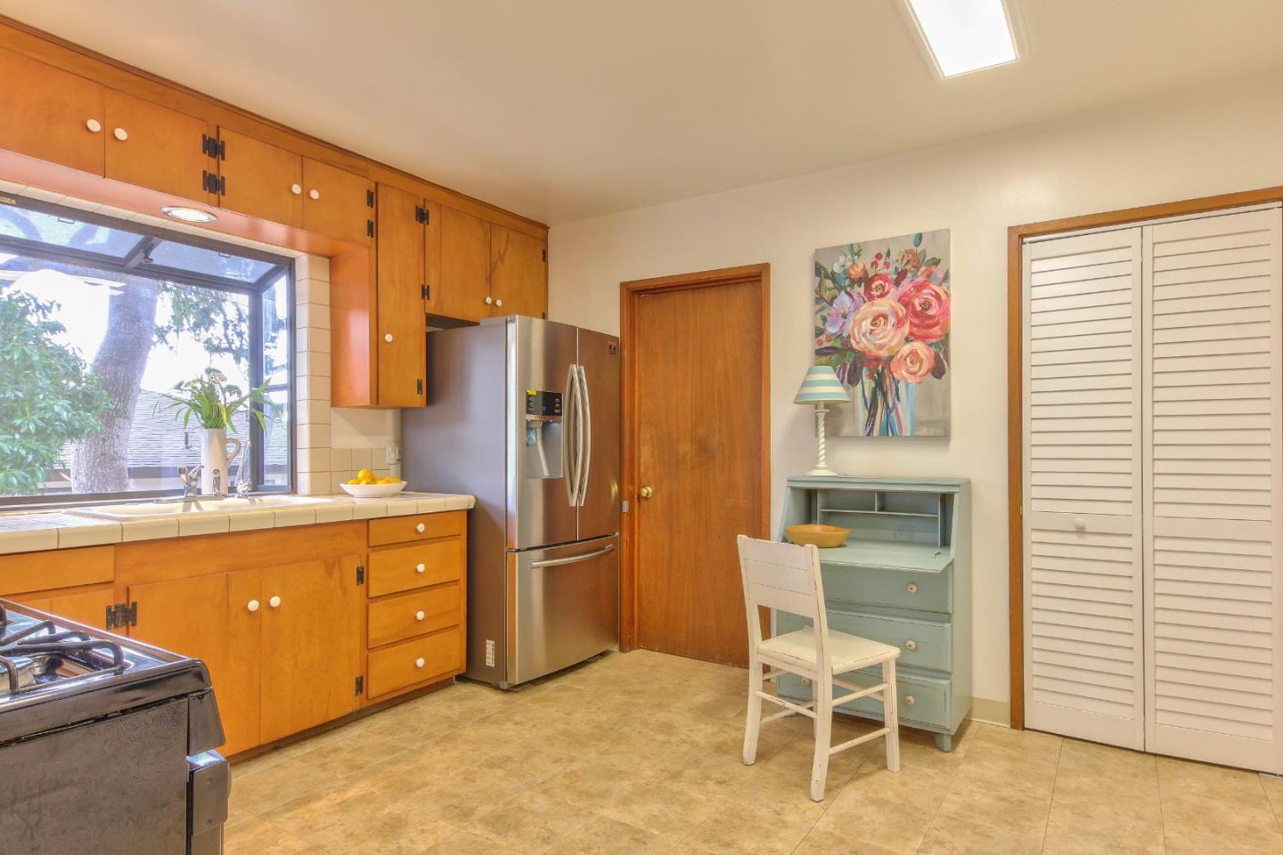 612 Sunset Drive Pacific Grove, CA 93950 - Photo 11 of 37 a kitchen with stainless steel appliances a refrigerator and a stove top oven