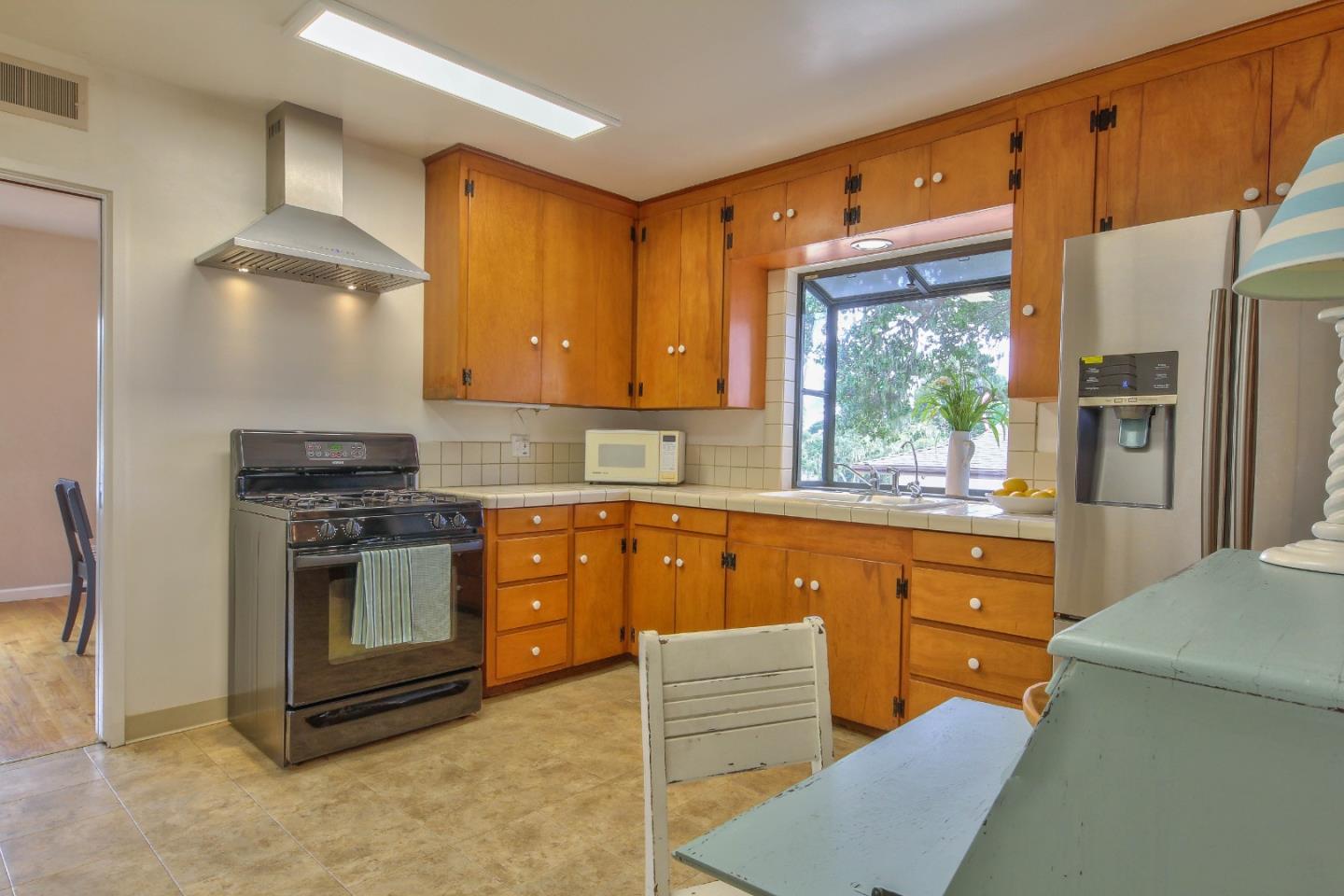 612 Sunset Drive Pacific Grove, CA 93950 - Photo 14 of 37 a kitchen with stainless steel appliances granite countertop a stove a sink and a refrigerator