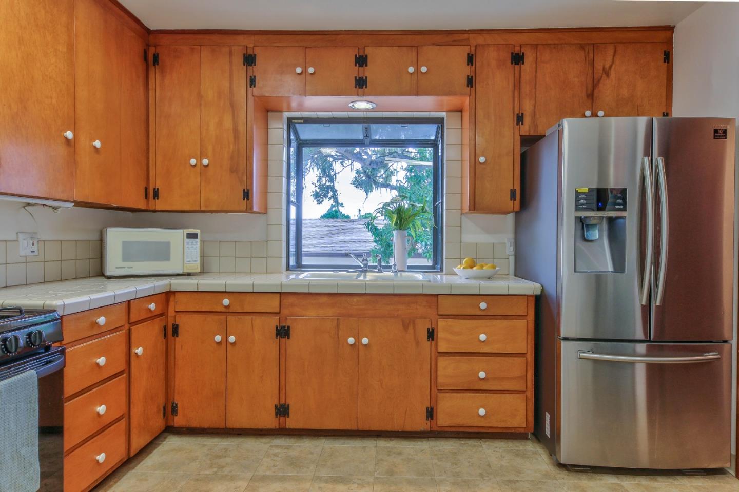 612 Sunset Drive Pacific Grove, CA 93950 - Photo 17 of 37 a kitchen with stainless steel appliances granite countertop a refrigerator and a sink