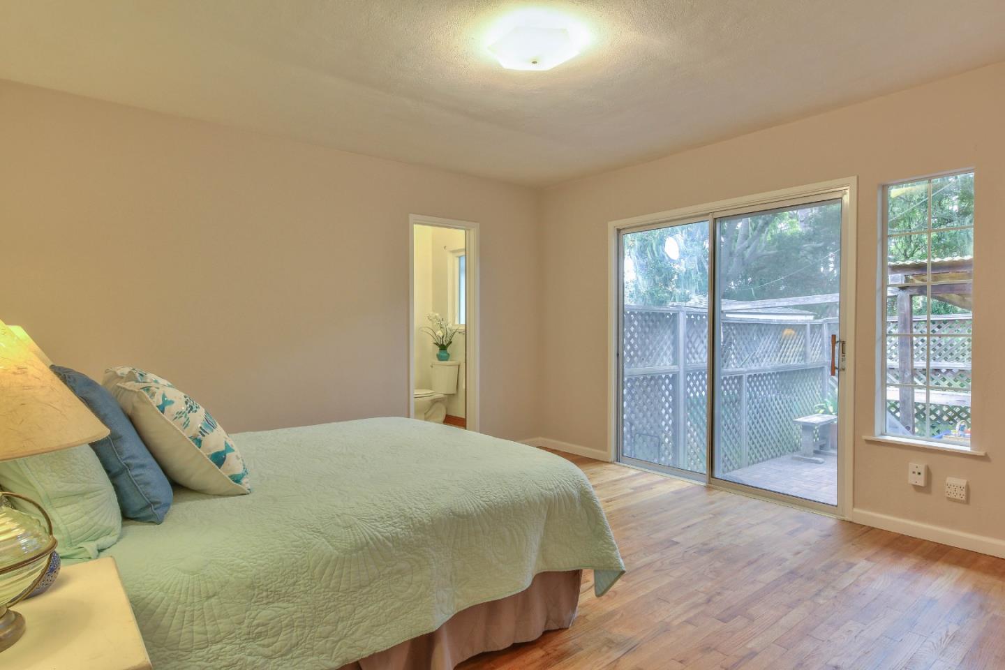 612 Sunset Drive Pacific Grove, CA 93950 - Photo 18 of 37 a bedroom with a bed and a window