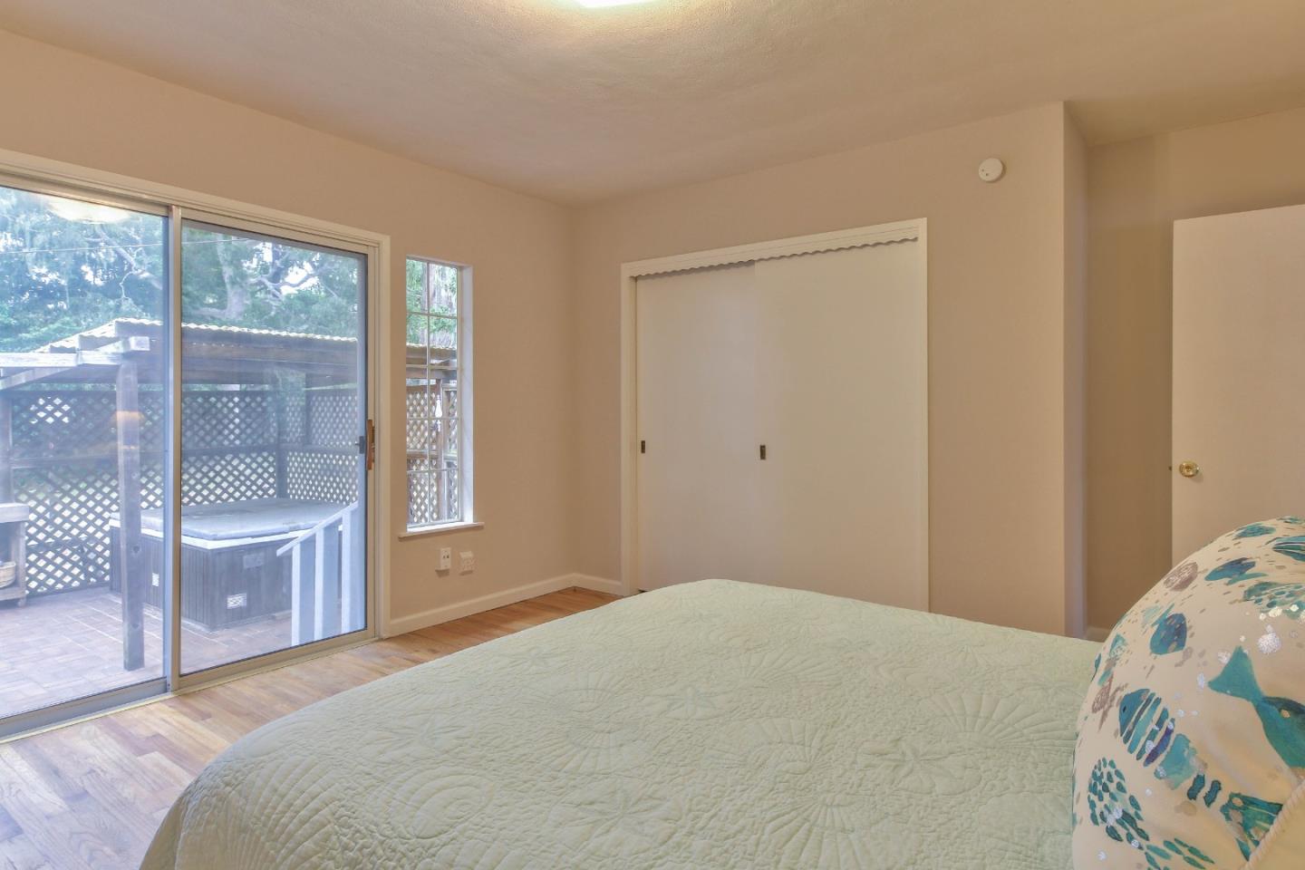 612 Sunset Drive Pacific Grove, CA 93950 - Photo 19 of 37 a bedroom with a large bed and a window