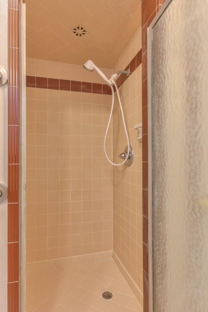612 Sunset Drive Pacific Grove, CA 93950 - Photo 23 of 37 a bathroom with a shower and a glass door