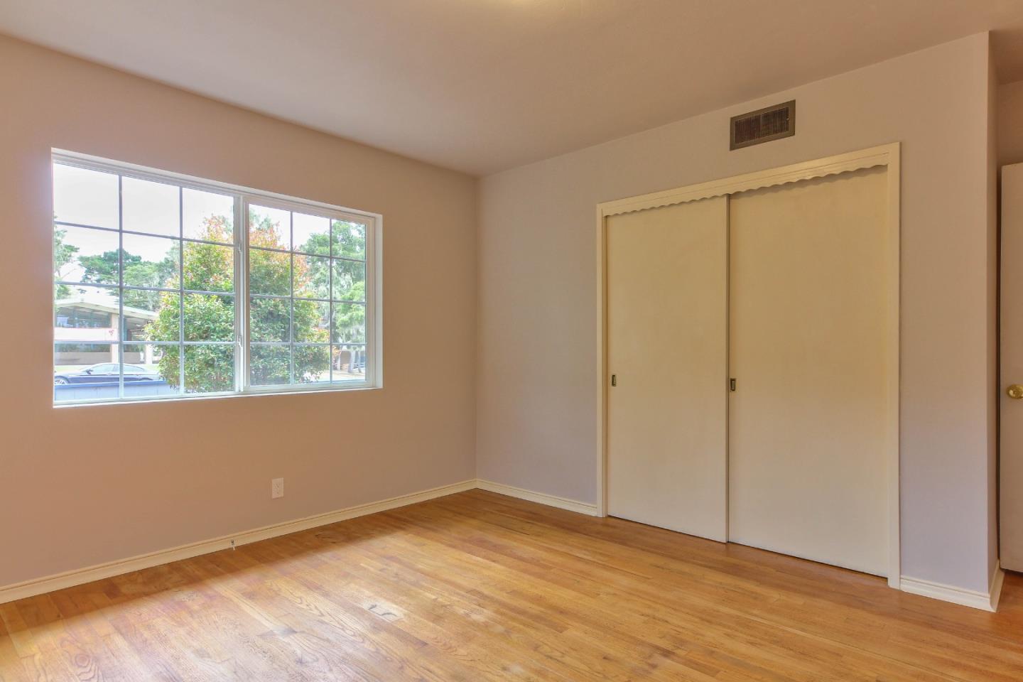 612 Sunset Drive Pacific Grove, CA 93950 - Photo 25 of 37 a view of an empty room with wooden floor and a window