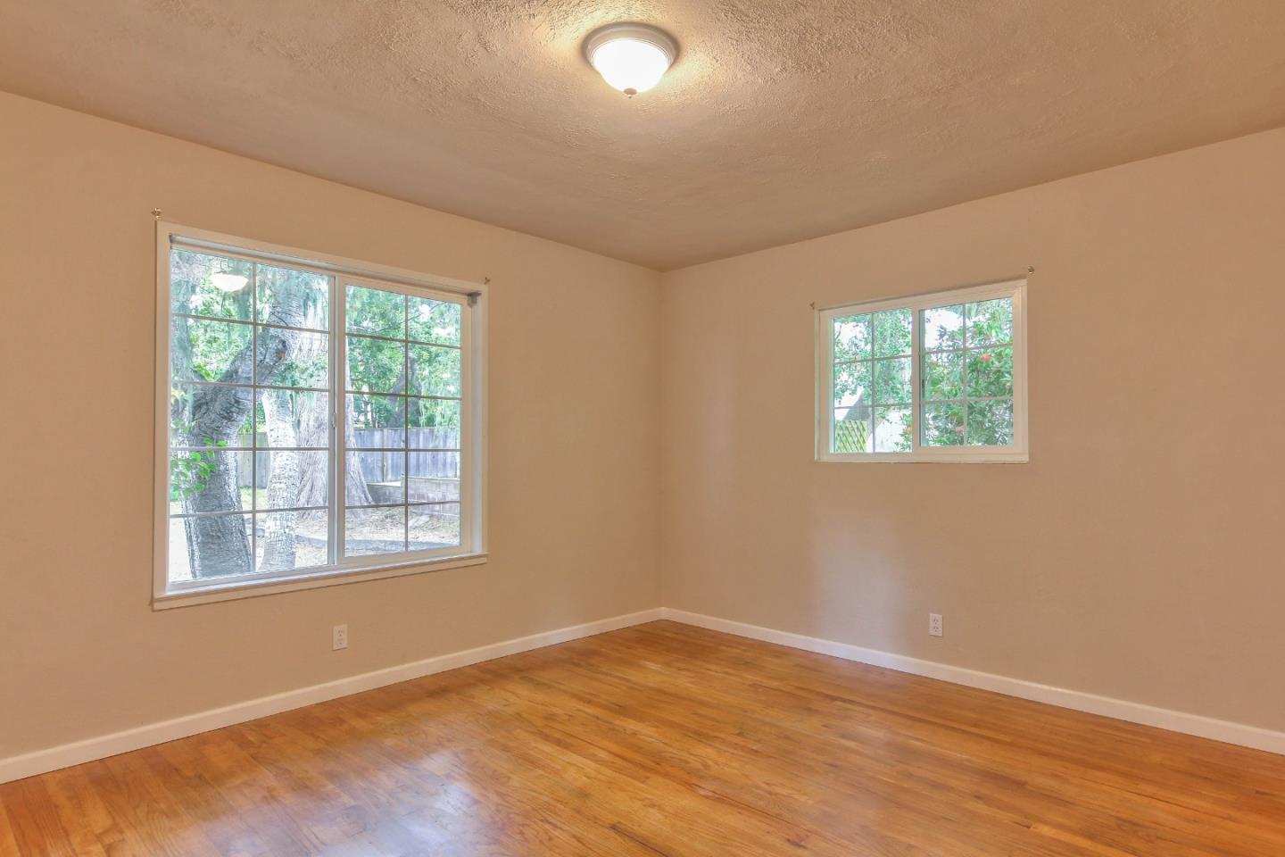 612 Sunset Drive Pacific Grove, CA 93950 - Photo 26 of 37 an empty room with wooden floor and windows