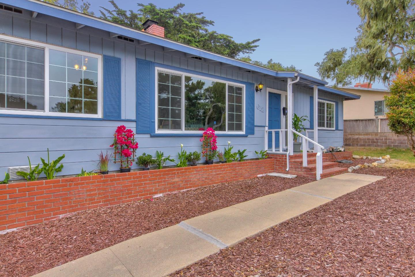 612 Sunset Drive Pacific Grove, CA 93950 - Photo 4 of 37 a front view of a house with a yard and a garage