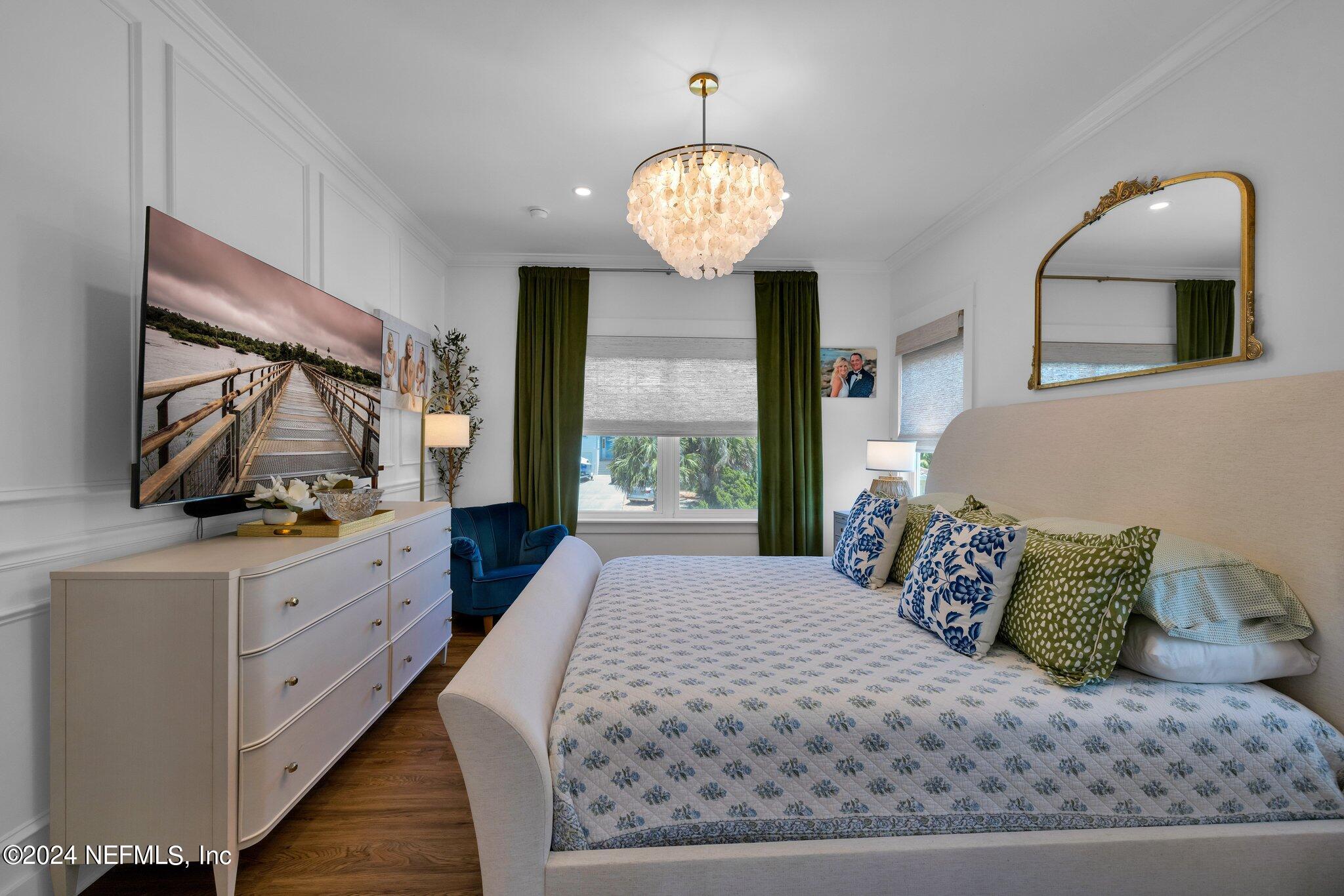 6825 A Ave Street St. Augustine, FL 32080 - Photo 21 of 53 a spacious bedroom with a bed and a mirror on the dresser