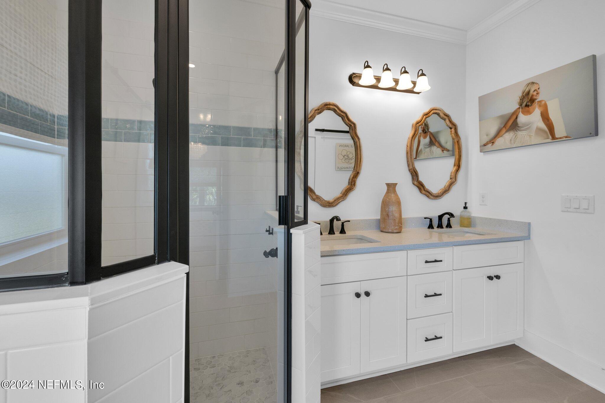 6825 A Ave Street St. Augustine, FL 32080 - Photo 23 of 53 a bathroom with a double vanity sink and a mirror