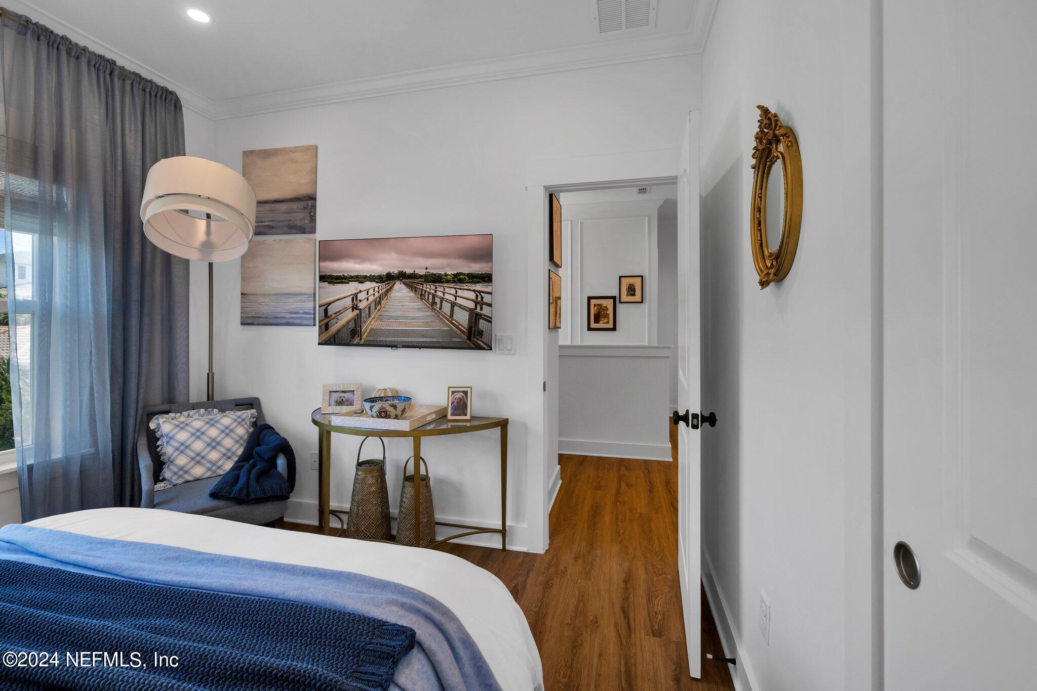 6825 A Ave Street St. Augustine, FL 32080 - Photo 35 of 53 a bedroom with a bed and wooden floor