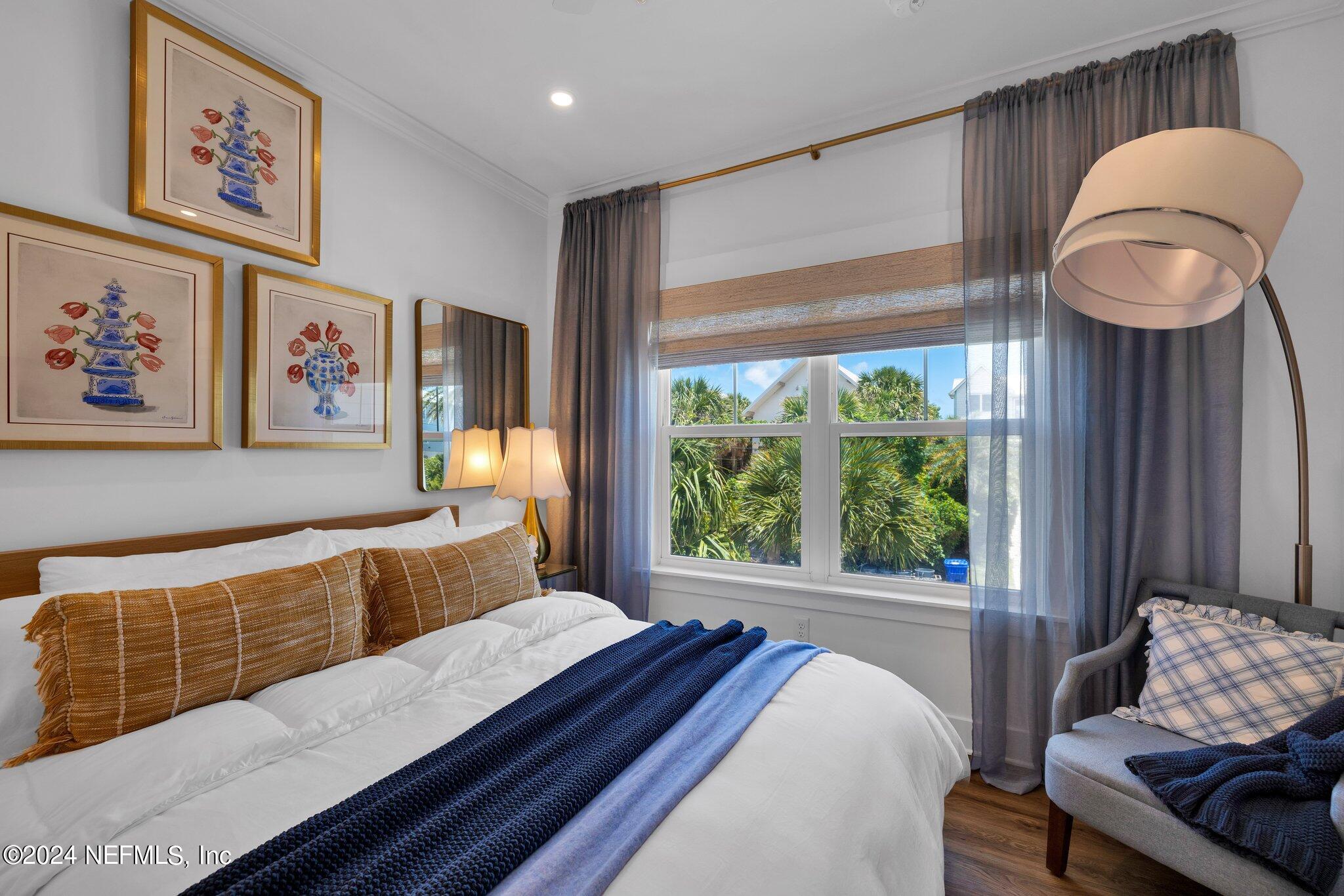 6825 A Ave Street St. Augustine, FL 32080 - Photo 37 of 53 a bedroom with a bed and dresser with wooden floor