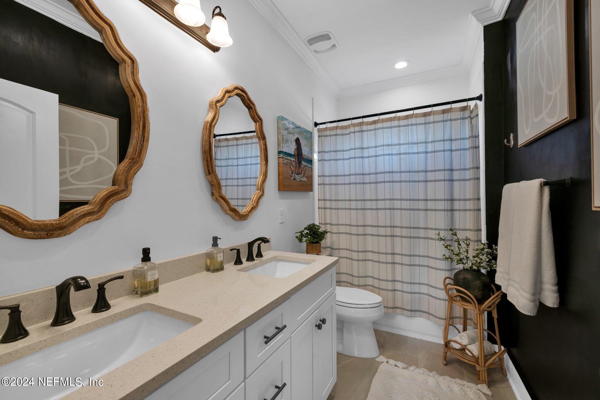 6825 A Ave Street St. Augustine, FL 32080 - Photo 39 of 53 a bathroom with a double vanity sink toilet and mirror
