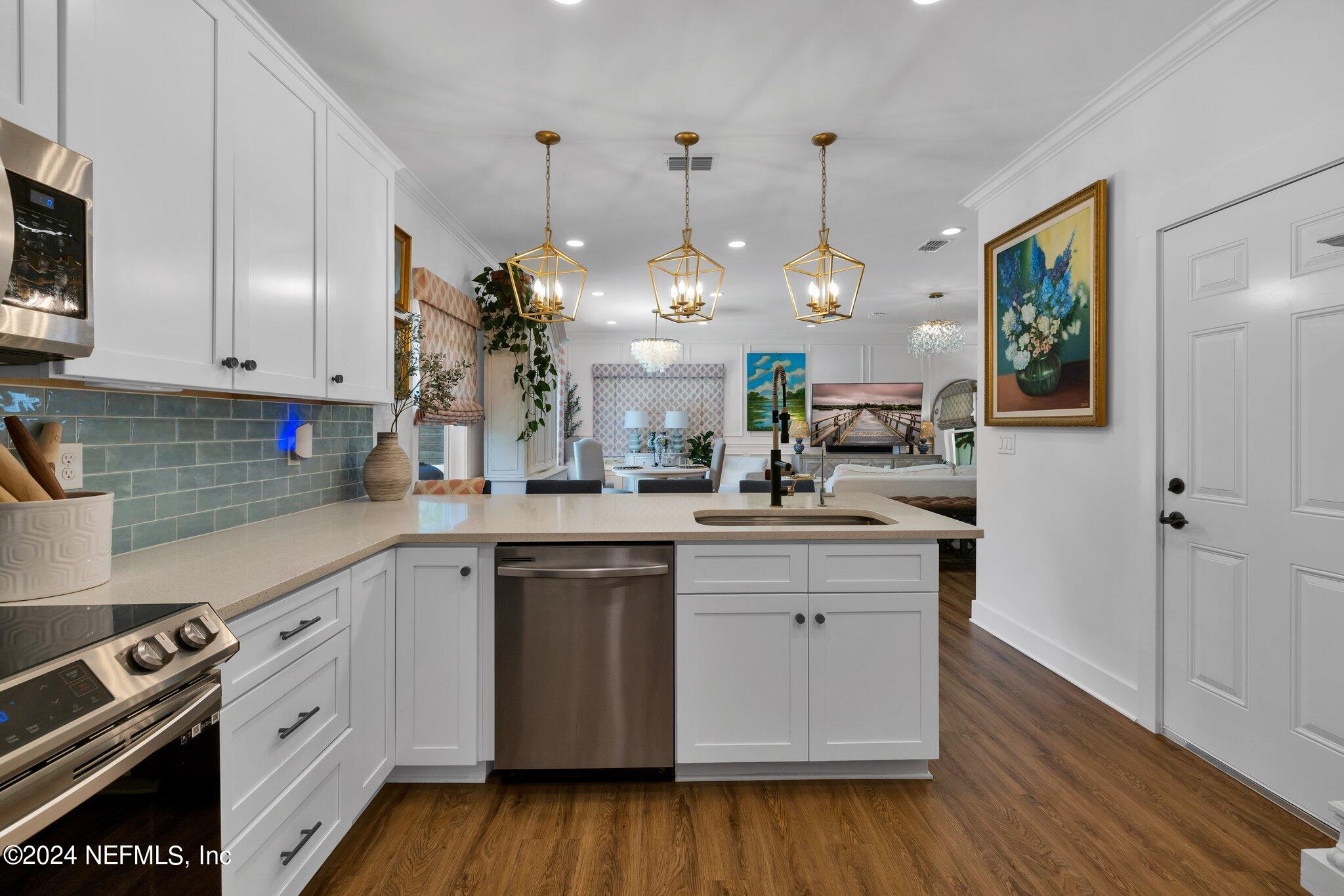 6825 A Ave Street St. Augustine, FL 32080 - Photo 47 of 53 a kitchen with a sink cabinets and wooden floor