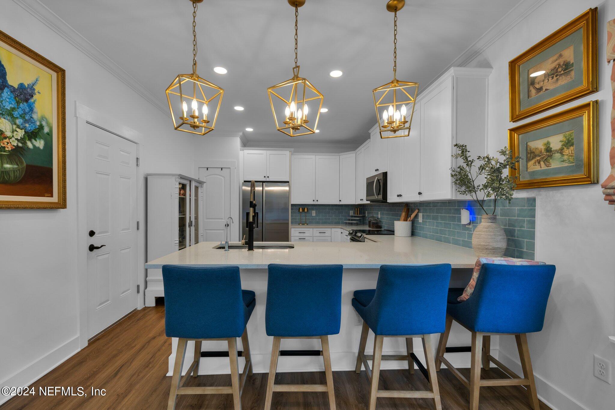 6825 A Ave Street St. Augustine, FL 32080 - Photo 48 of 53 a kitchen with a dining table and chairs