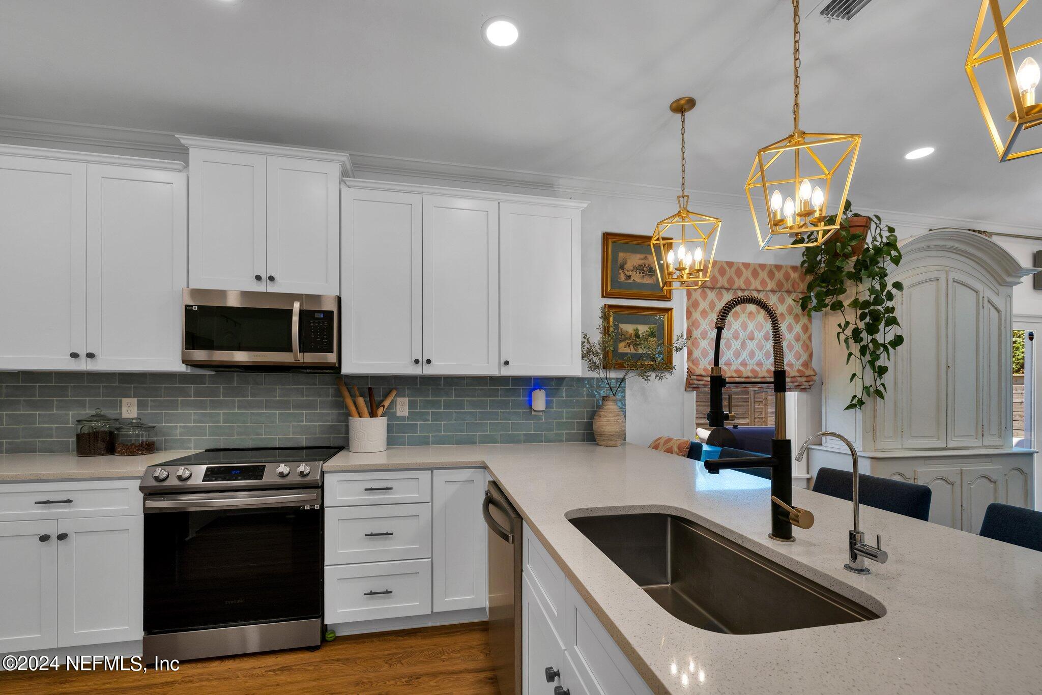 6825 A Ave Street St. Augustine, FL 32080 - Photo 50 of 53 a kitchen with granite countertop a sink stainless steel appliances and cabinets