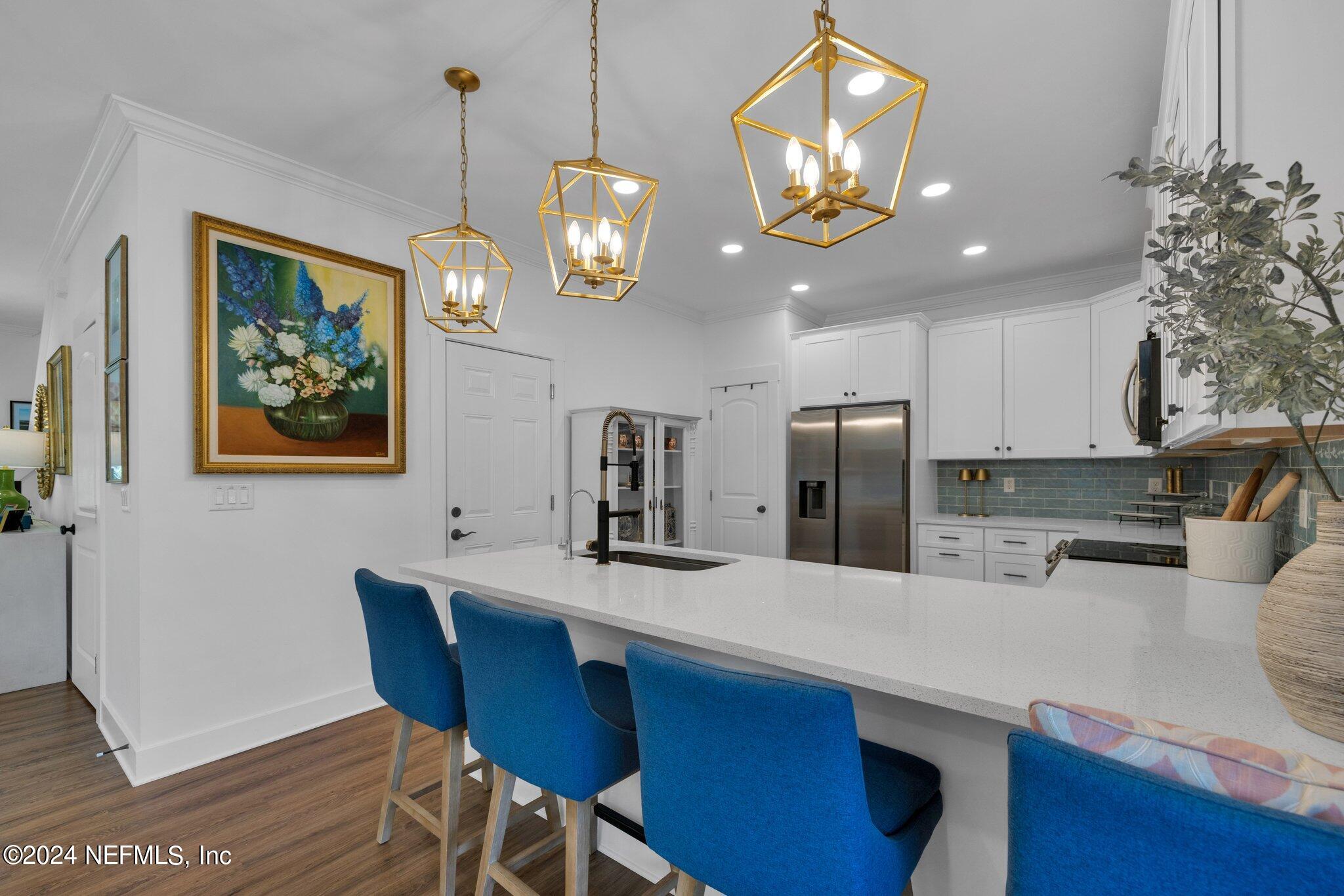 6825 A Ave Street St. Augustine, FL 32080 - Photo 51 of 53 a kitchen with stainless steel appliances granite countertop a dining table and chairs