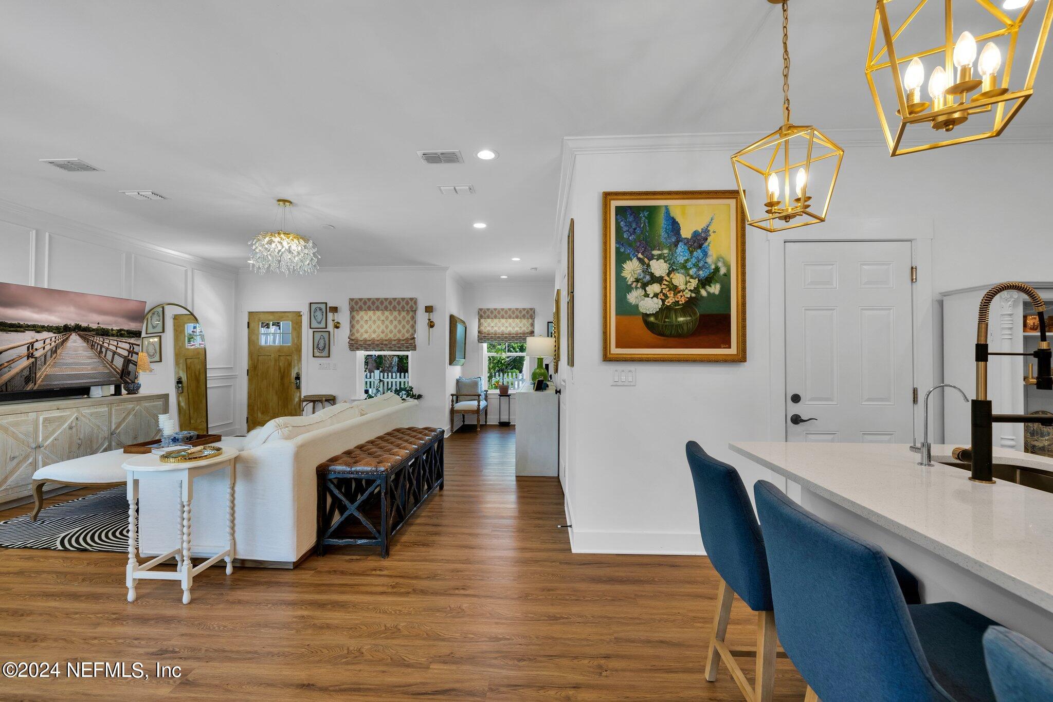6825 A Ave Street St. Augustine, FL 32080 - Photo 52 of 53 a view of a dining room with furniture a chandelier and wooden floor