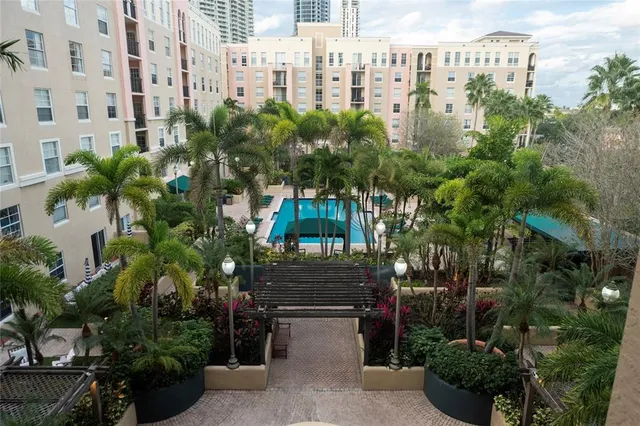 a view of a house with a fountain and a potted plant