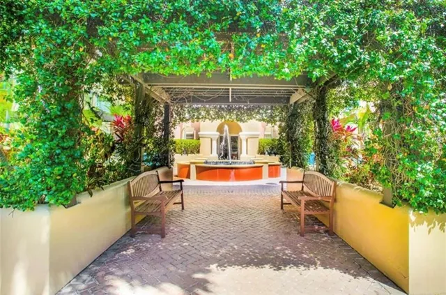 a living room with furniture a flat screen tv and large window
