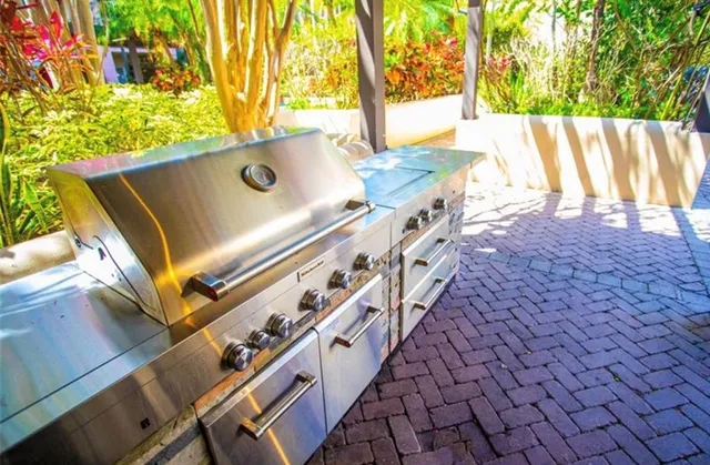 a kitchen with stainless steel appliances granite countertop a stove and cabinets