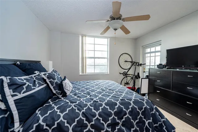 a bedroom with a bed and ceiling fan