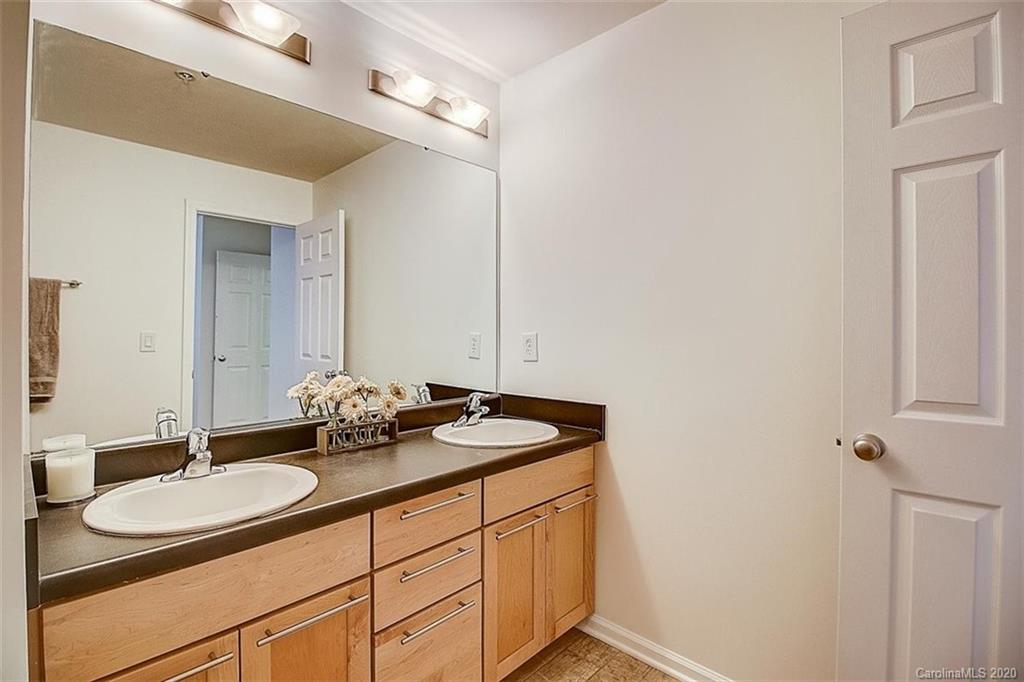652 Raphael Place Charlotte, NC 28205 - Photo 11 of 26 a bathroom with a granite countertop sink and a mirror