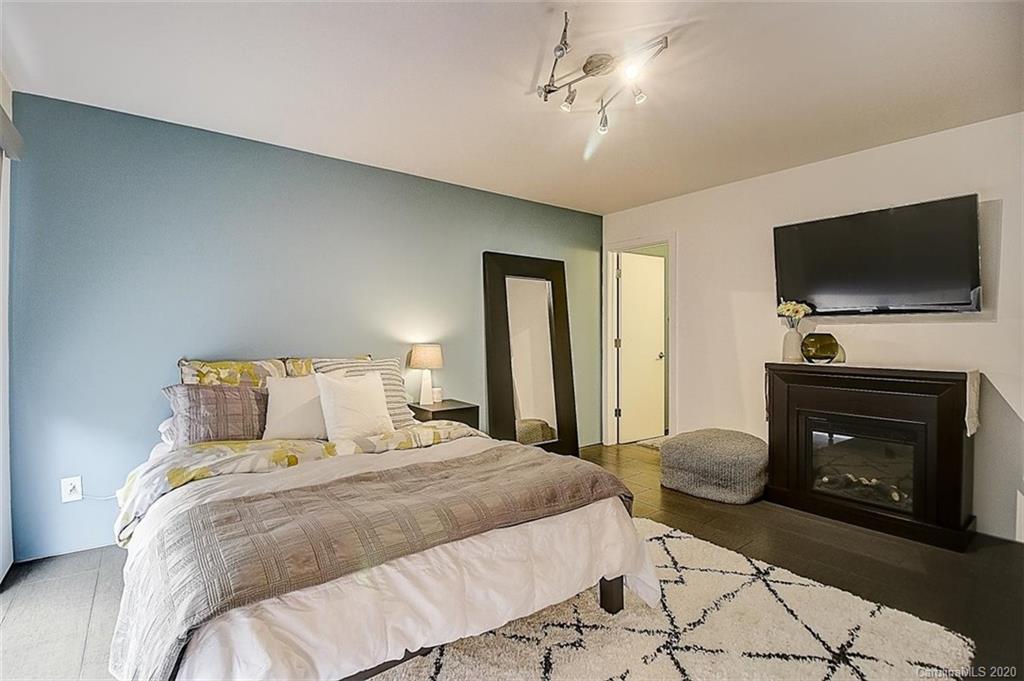 652 Raphael Place Charlotte, NC 28205 - Photo 16 of 26 a bedroom with a bed and a television