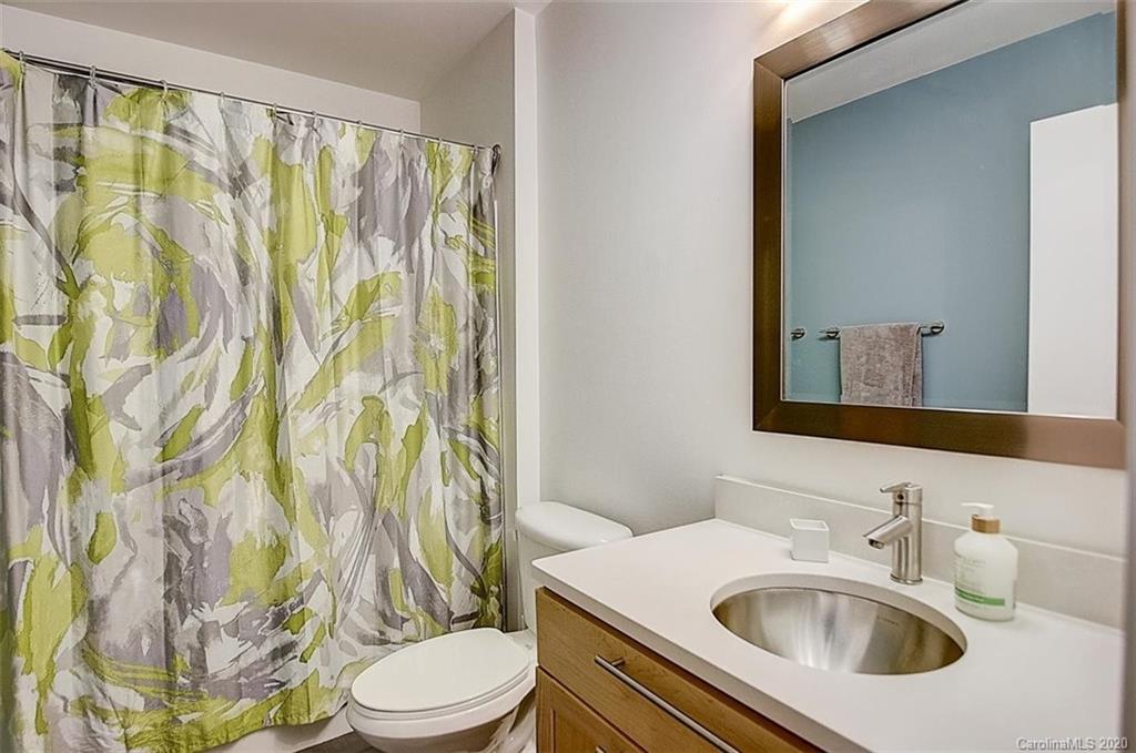 652 Raphael Place Charlotte, NC 28205 - Photo 17 of 26 a bathroom with a sink and a mirror