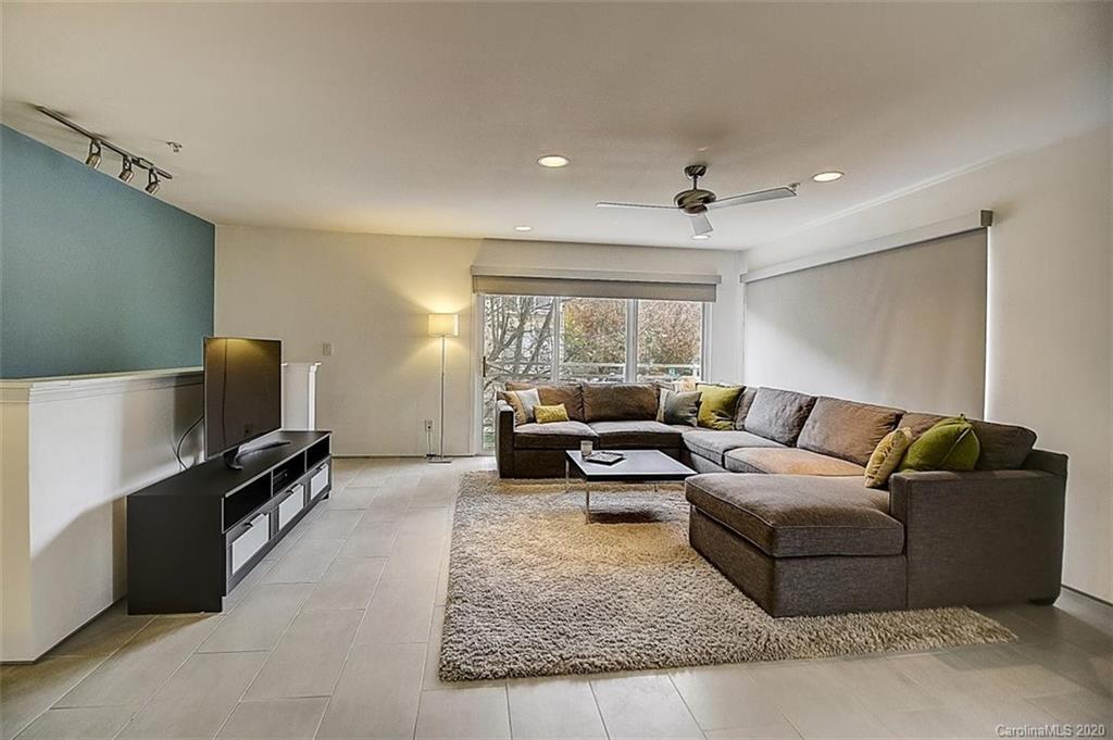 652 Raphael Place Charlotte, NC 28205 - Photo 4 of 26 a living room with furniture and a flat screen tv