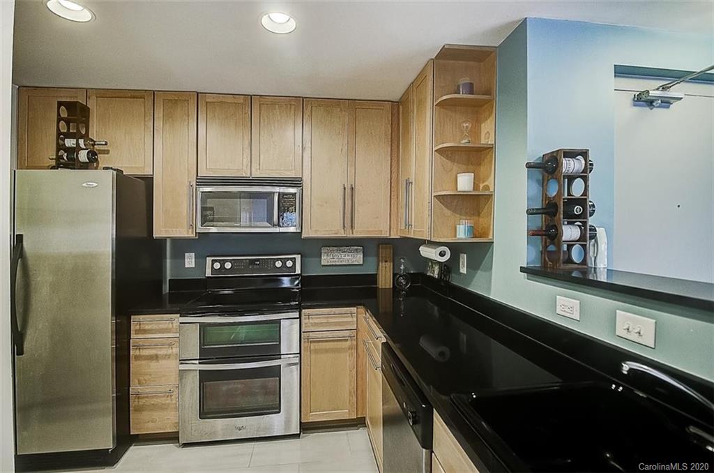 652 Raphael Place Charlotte, NC 28205 - Photo 7 of 26 a kitchen with a refrigerator and a sink