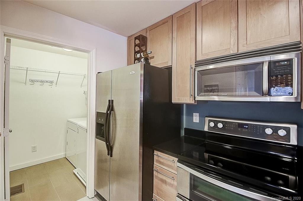 652 Raphael Place Charlotte, NC 28205 - Photo 8 of 26 a kitchen with stainless steel appliances a refrigerator and a stove top oven