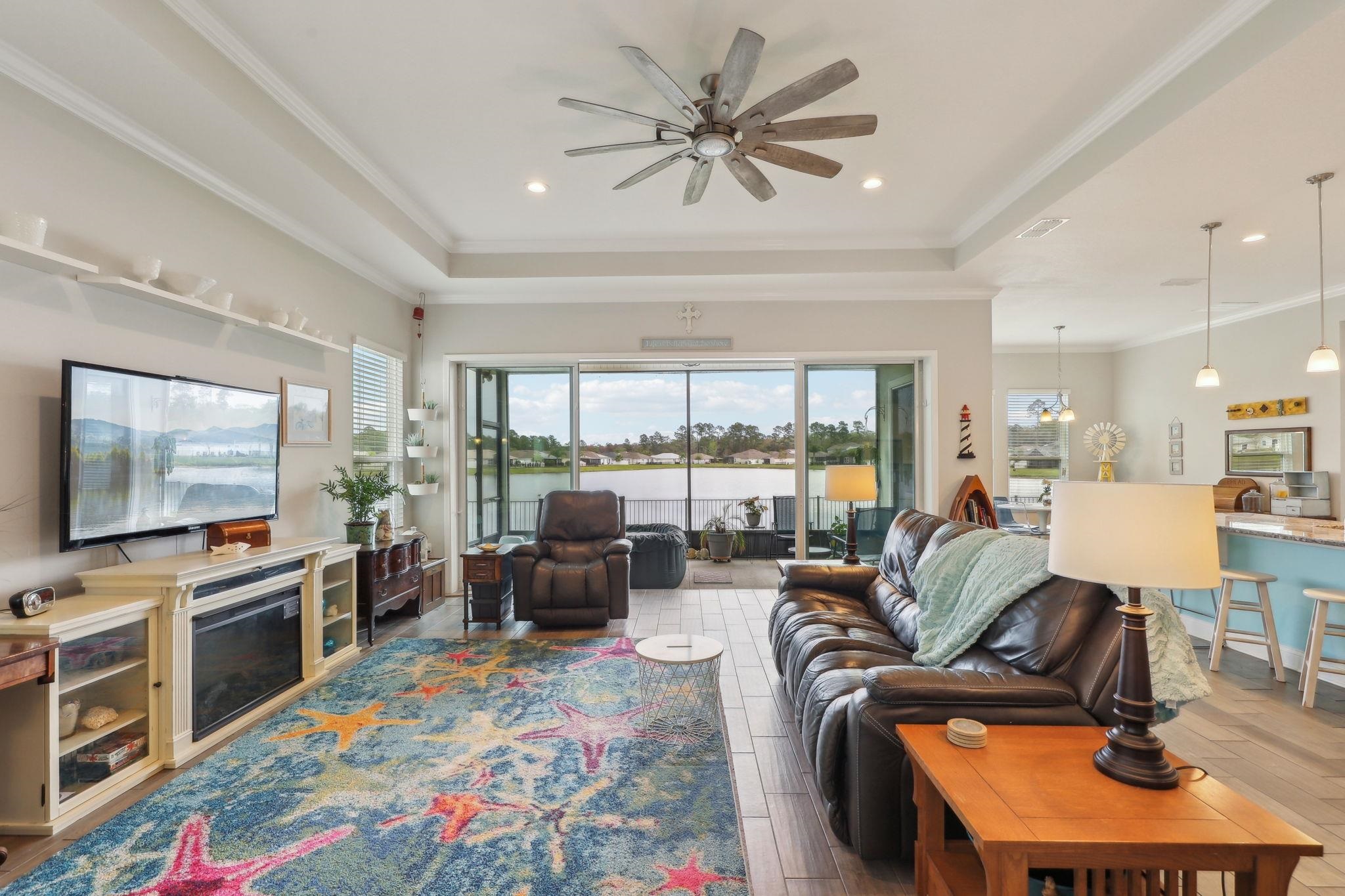 443 Sweet Mango Trail St. Augustine, FL 32086 - Photo 11 of 54 a living room with furniture and a flat screen tv