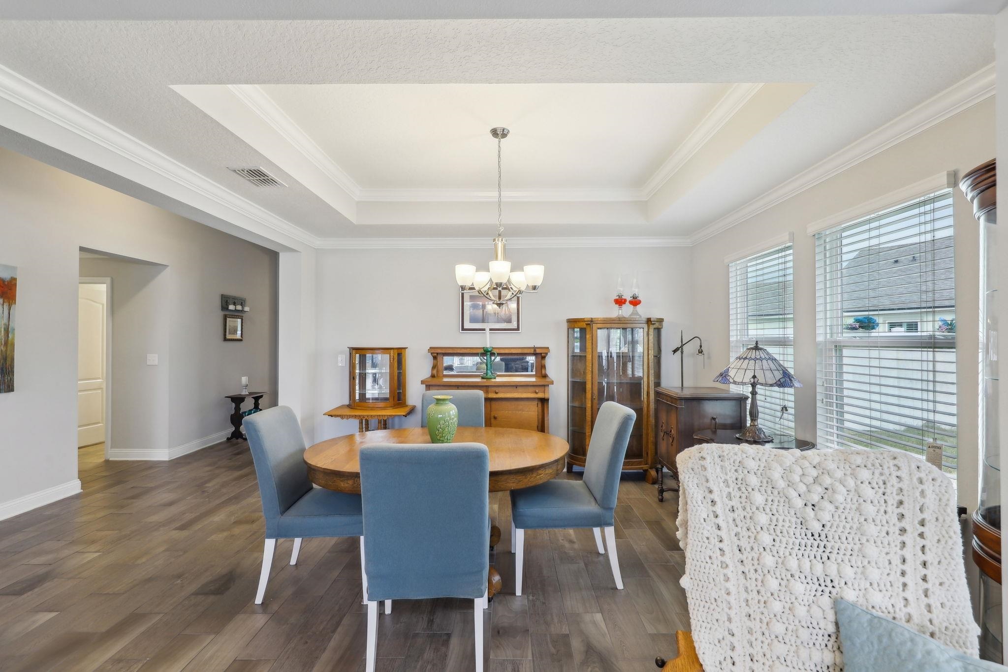 443 Sweet Mango Trail St. Augustine, FL 32086 - Photo 12 of 54 a view of a dining room with furniture window and wooden floor