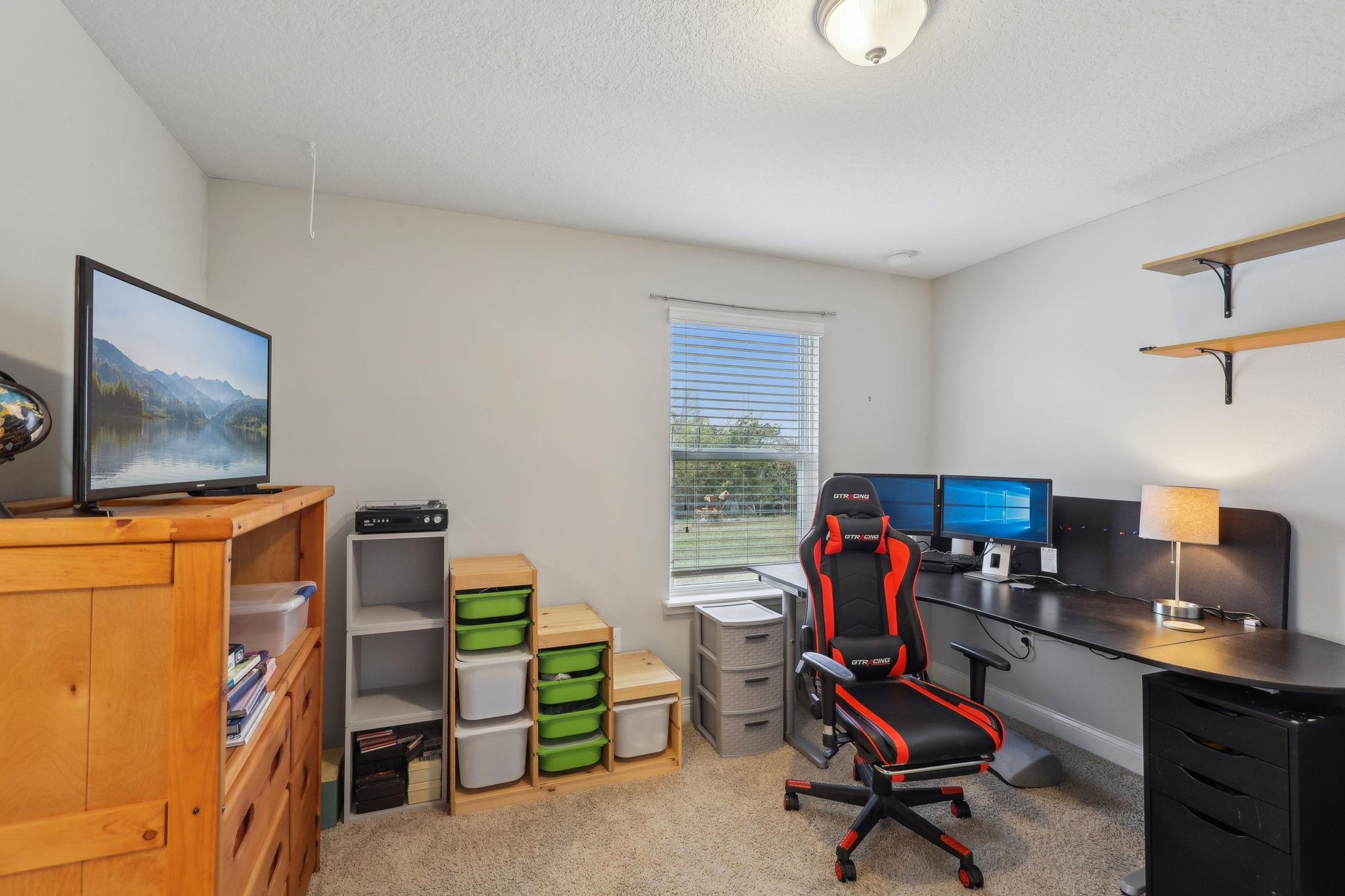 443 Sweet Mango Trail St. Augustine, FL 32086 - Photo 19 of 54 a living room with furniture and a flat screen tv