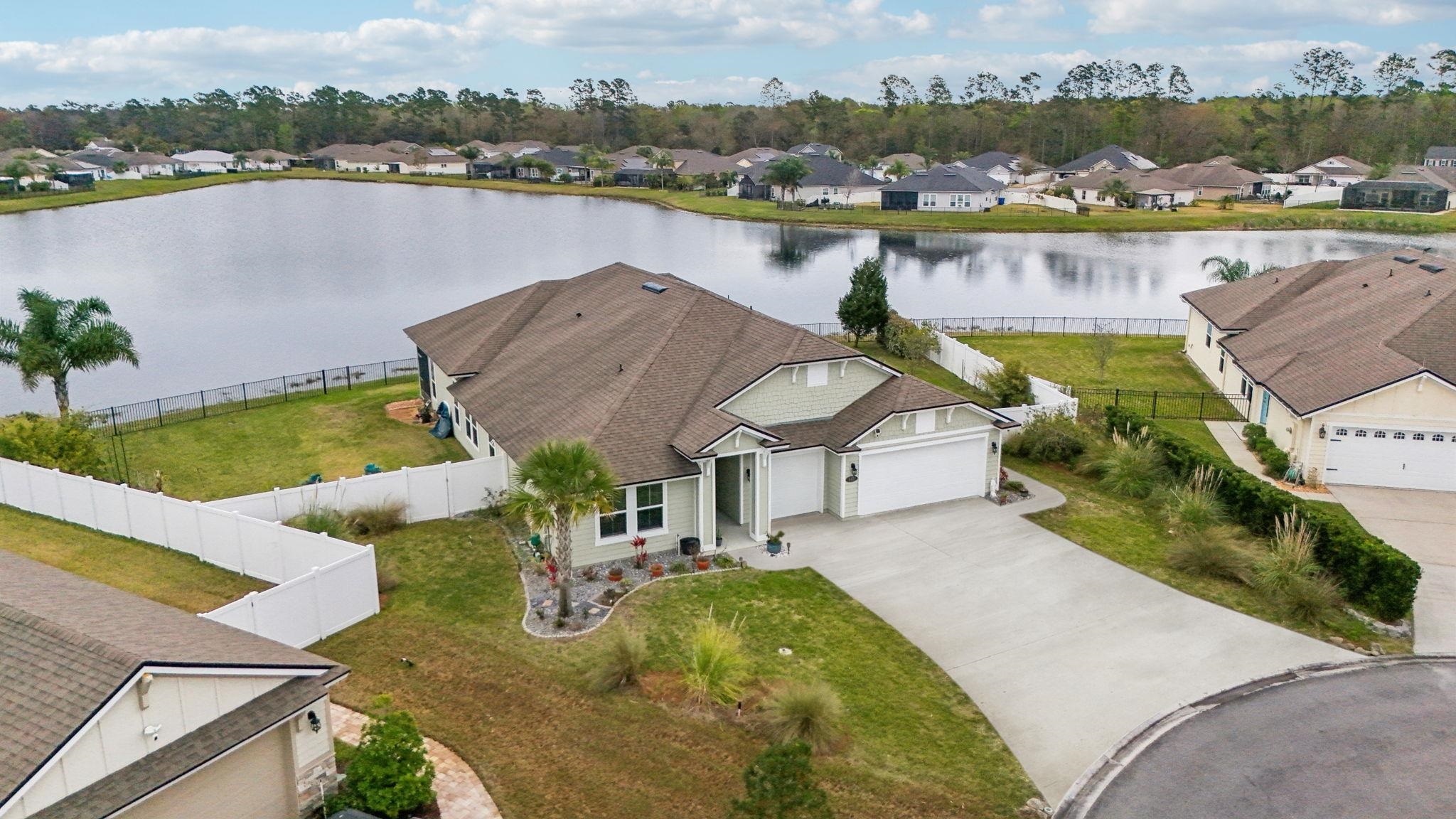 443 Sweet Mango Trail St. Augustine, FL 32086 - Photo 2 of 54 an aerial view of a house with a lake view