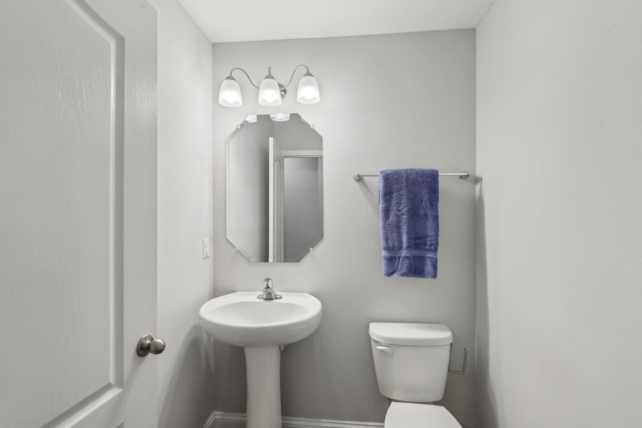 443 Sweet Mango Trail St. Augustine, FL 32086 - Photo 21 of 54 a bathroom with a toilet sink and mirror